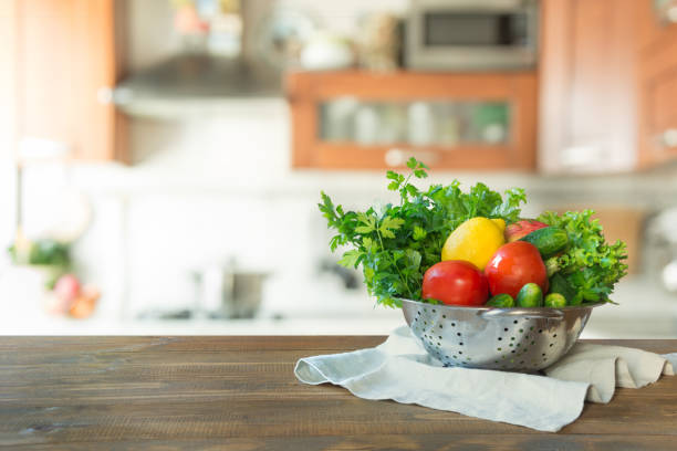 istock Blurred background. Modern kitchen with empty wooden tabletop, space for you and display your products. 1047757478