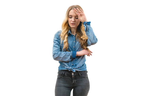 istock The woman with a headache standing on the white background 1047769462