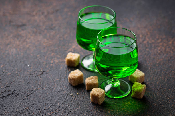 Glasses of absinthe with brown sugar Glasses of green alcoholic drink absinthe with brown sugar absinthe spoon stock pictures, royalty-free photos & images