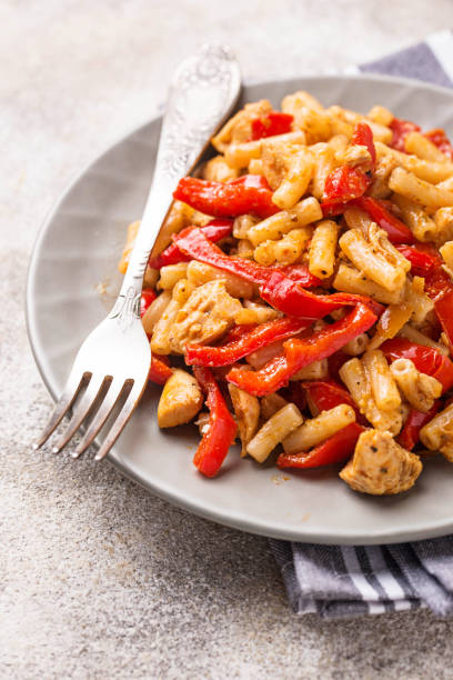 istock Pasta with chicken and pepper in tomato sauce 1047769586