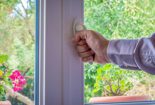 istock Male hand on the handle of a  window 1047774298