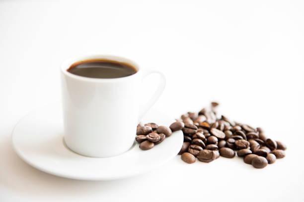 istock black coffee and roasted beans on white clear background 1047774842