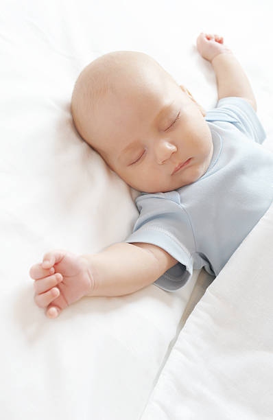 istock A sleeping baby with his arms outstretched 104777532