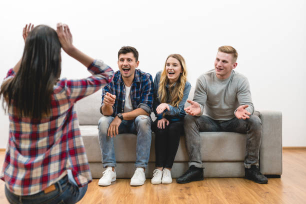 istock The four friends fun on the white wall background 1047779020