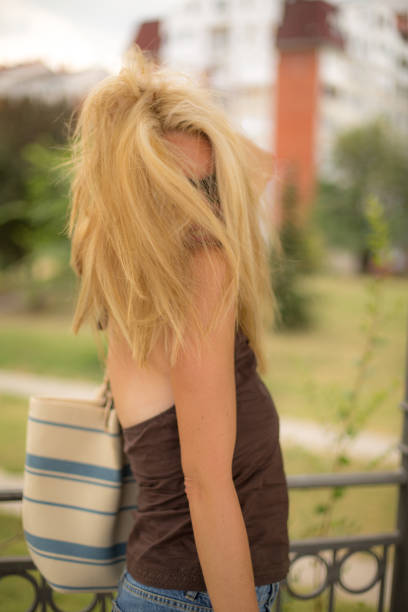 Blonde haired and petite lady walking in nature on the weekend