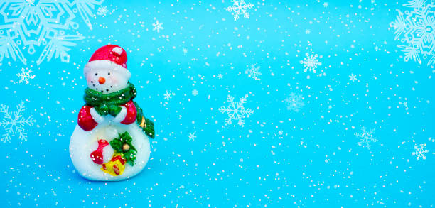 istock Winter background with a snowman, snow and snowflakes 1047784854