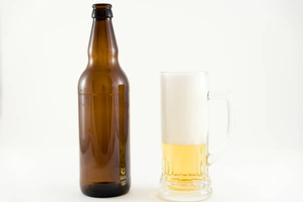 istock beer bottles with glass cup on white background 1047788582