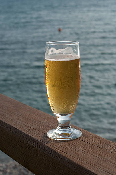istock glass of beer on the railing 104779037
