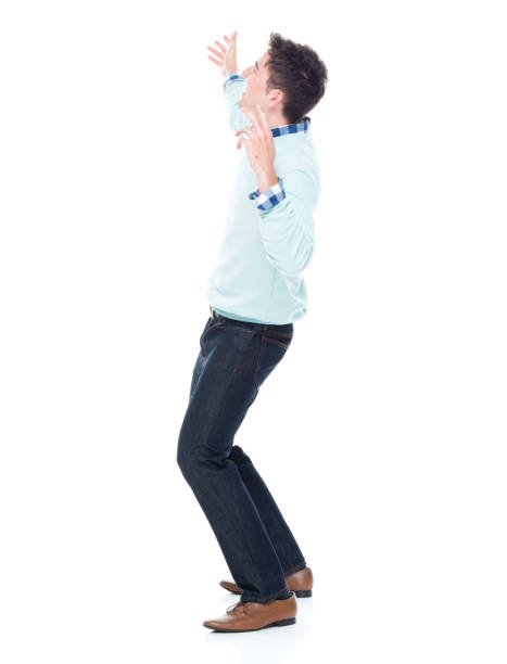 istock Handsome young man looking up in surprise 1047791884