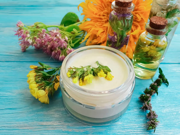 istock extract, cosmetic cream, flower on a wooden background 1047792132