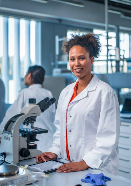istock Smiling scientist with digital tablet in laboratory 1047801704