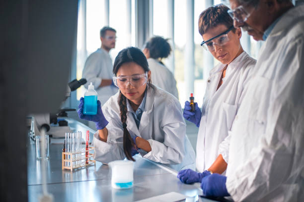 istock Female scientist looking at chemical reaction 1047801742