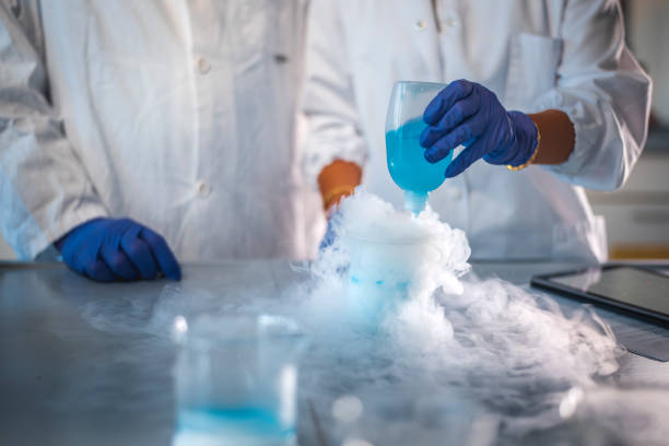 istock Researcher pouring chemical into flask 1047801756