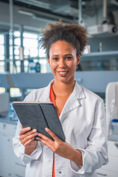 istock Smiling scientist with digital tablet in laboratory 1047801762