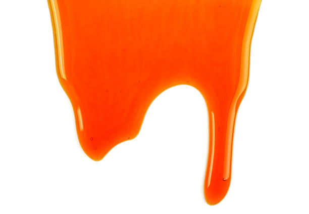 istock Sweet caramel sauce isolated on white background 1047801822