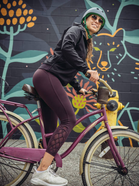 istock Young woman on cruiser bicycle 1047804912