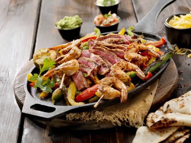 Grilled Steak and Shrimp Fajita Platter Grilled Steak and Shrimp Fajita Platter fresh cilantro stock pictures, royalty-free photos & images