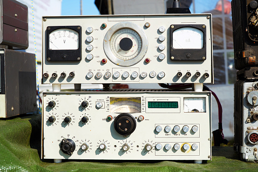 Old radio engineering devices. Scale with arrow, transceiver, measuring instruments