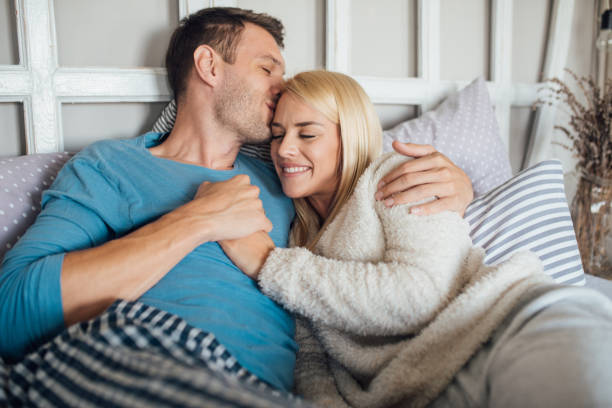 istock Young couple cuddling in bed 1047810422