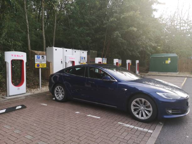 Tesla Charging on the Tesla Charge point in West Midlands Service in M40 After Gaydon before Warwick exit Warwickshire, UK - October 1st, 2018 : Tesla Charging on the Tesla Charge point in West Midlands Service in M40 After Gaydon before Warwick exit m40 sniper rifle stock pictures, royalty-free photos & images