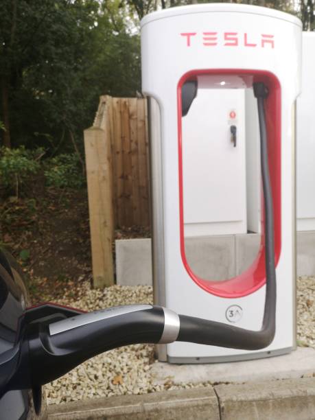 Tesla Charging on the Tesla Charge point in West Midlands Service in M40 After Gaydon before Warwick exit Warwickshire, UK - October 1st, 2018 : Tesla Charging on the Tesla Charge point in West Midlands Service in M40 After Gaydon before Warwick exit m40 sniper rifle stock pictures, royalty-free photos & images