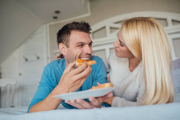 istock Young man having breakfast in bed 1047813660