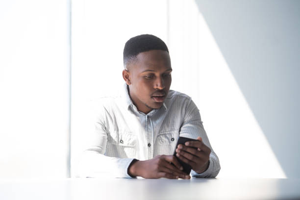 istock Confident businessman holding his smart phone 1047817440
