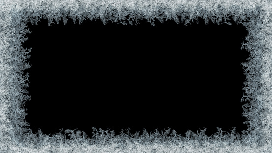 Beautiful frost pattern on a window in blue tones. Can be used as a winter / holiday background.