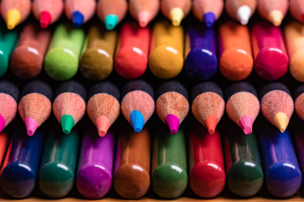 istock A Macro close up of a stack of colored pencils where every other row is tips and opposing rows are butt ends.  The pencils have black barrels and  1 row of tips in in sharp focus. 1047836440