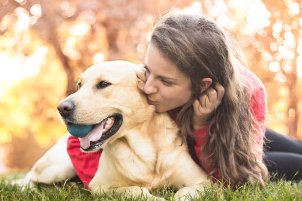 istock Young smiling woman with her cute dog 1047836930