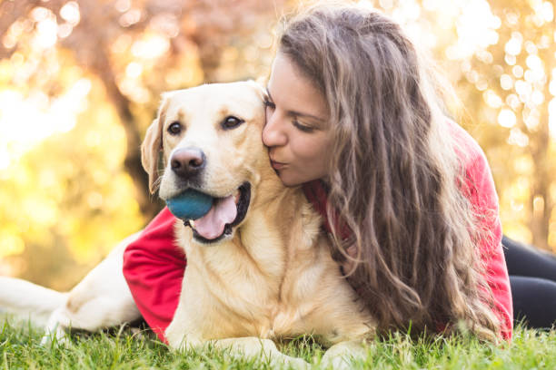 istock Young smiling woman with her cute dog 1047836984