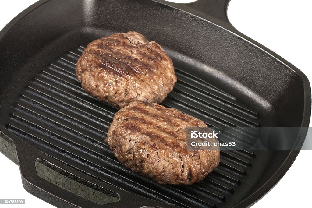 Grilling Hamburgers Two thick juicy hamburgers in a grill pan Beef Stock Photo