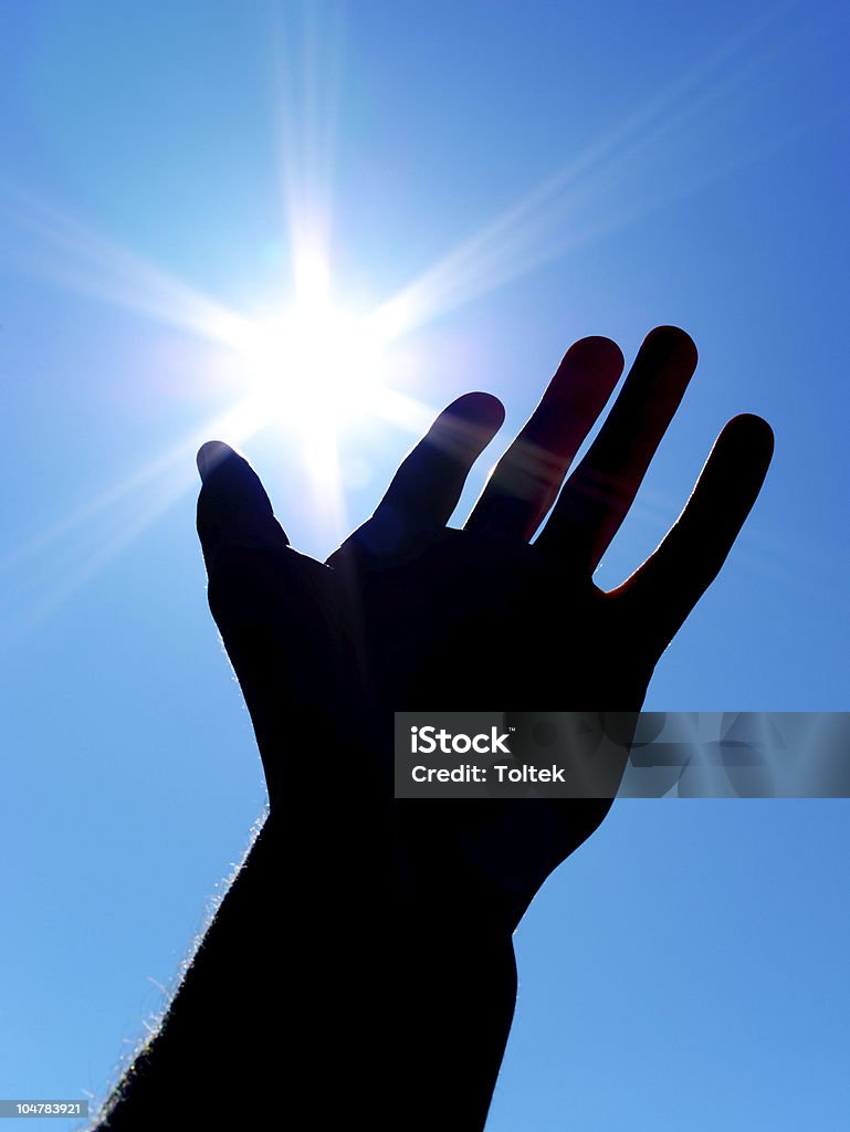 Sun on palm Sun on palm. Silhouette of human hand. Concept design. Star Shape Stock Photo