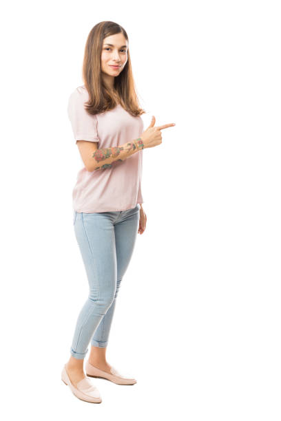 istock Beautiful Female Pointing Towards Blank Space On White Background 1047848706
