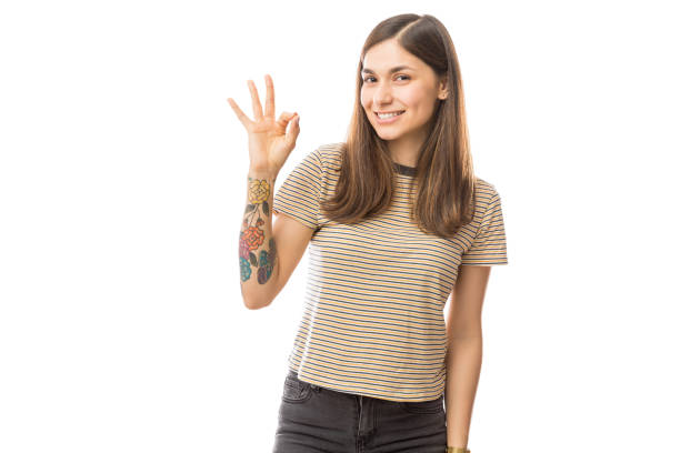istock Female Showing Ok Gesture Over Plain Background 1047849212