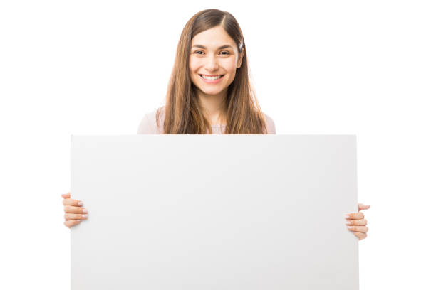 istock Happy Woman Holding Blank Billboard Over White Background 1047849334