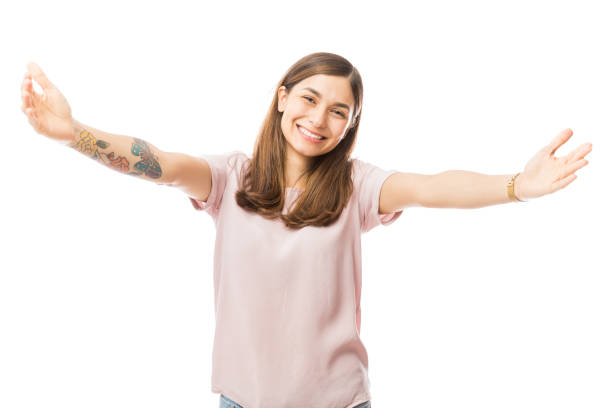 Loving Woman Offering A Hug Over White Background Portrait of loving young woman offering a hug over white background arms outstretched stock pictures, royalty-free photos & images