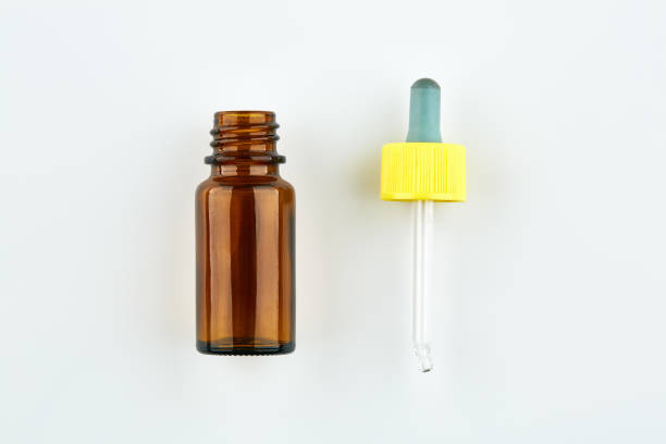 istock Brown medicine vial and pipette on white background 1047852280
