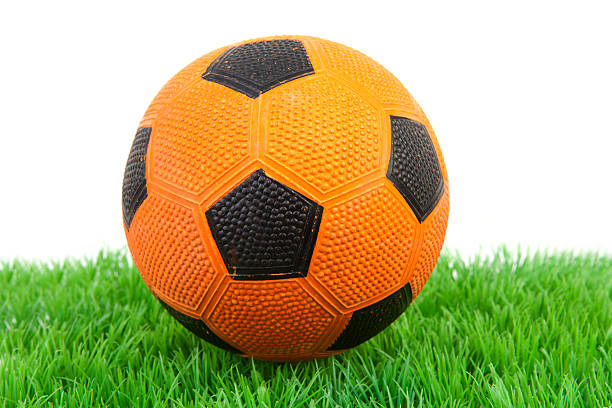 istock Orange soccer ball  on grass 104787085