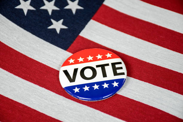 istock campaign vote button on American flag 1047875076