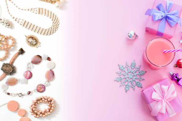 istock Festive background for text composition flat lay Christmas items gift box ribbon bow pink glass cocktail Christmas toys Top view copy space 1047875752
