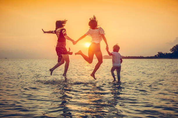 istock family is running on the beach 1047876100