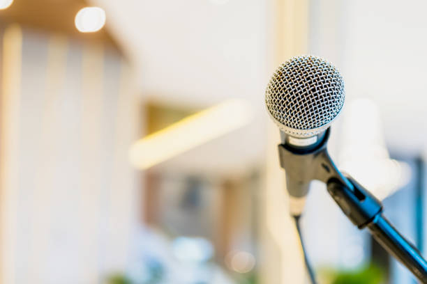 istock close-up microphone on stage event hall with blur background 1047876696