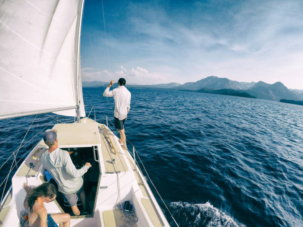 A family camps and enjoys the beauty of Emerald Bay in Lake Tahoe, California while paddle boarding, sailing, and swimming