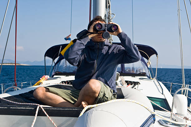 istock Man with binocular on the yacht 104788592