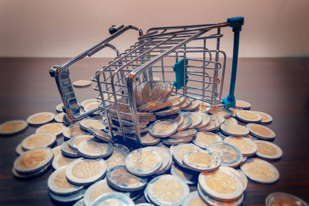 shopping cart and euro money overturned trolley car and scattared lot of many two euro metal coins birch gold group review and prices stock pictures, royalty-free photos & images