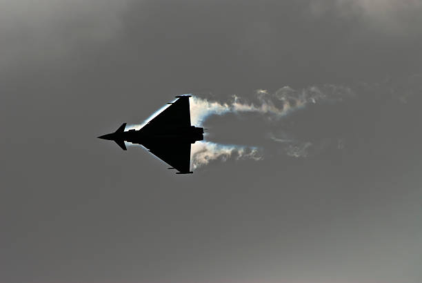 typhoon eurofighter in silhouette stock photo