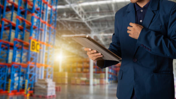istock Businessman manager looking the tablet check and control for workers with Modern Trade warehouse logistics. Industry 4.0 concept 1047909680