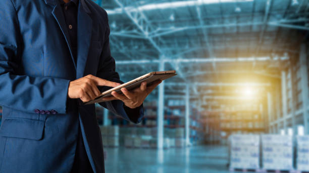 istock Businessman manager using tablet check and control for workers with Modern Trade warehouse logistics. Industry 4.0 concept,planning of logistics, Transportation within the country and Global. 1047909740