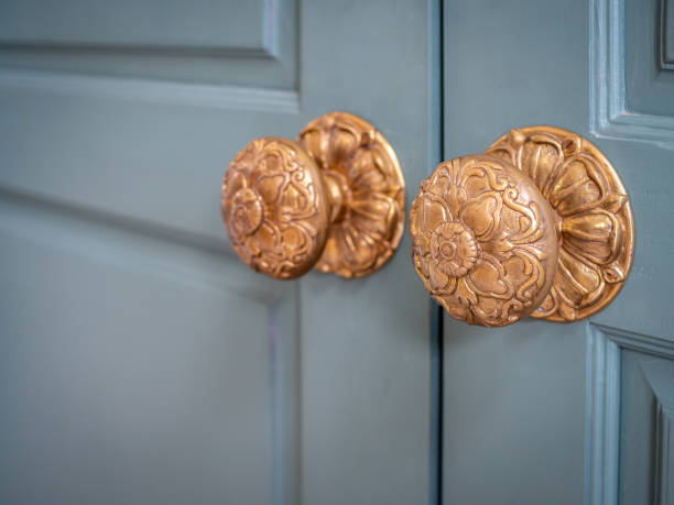 istock Vintage door knobs on wooden door 1047941268